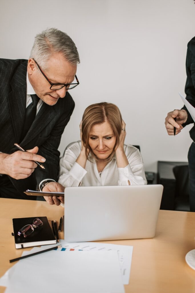 Business professionals discussing ideas and a project on a laptop